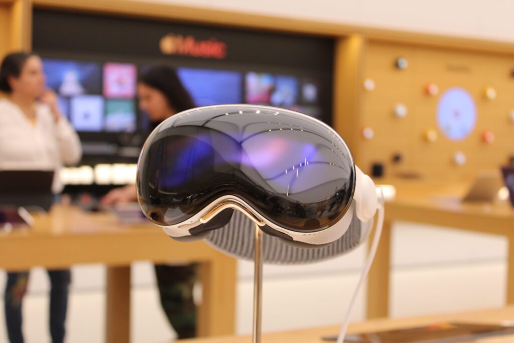 A person wearing the Apple Vision Pro headset gestures in the air while digital windows float in their surroundings.