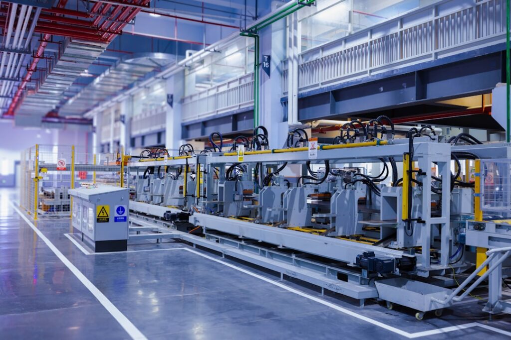 A technician inspects a wafer etching machine in a cleanroom semiconductor fab facility.